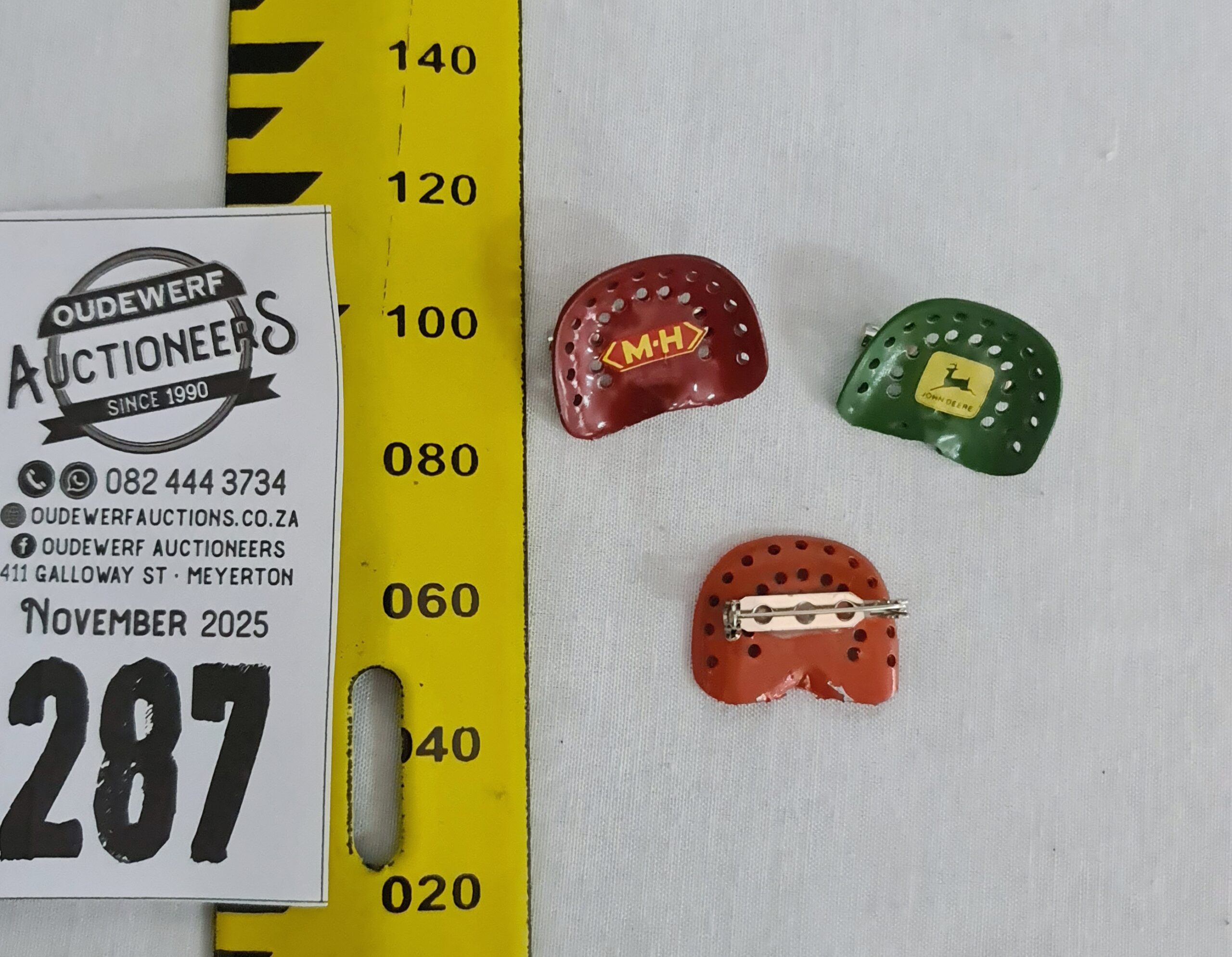 287.  3 x Metal mini tractor-seat shaped brooches- Case, Massey Harris and John Deere -Est R500-R1,000