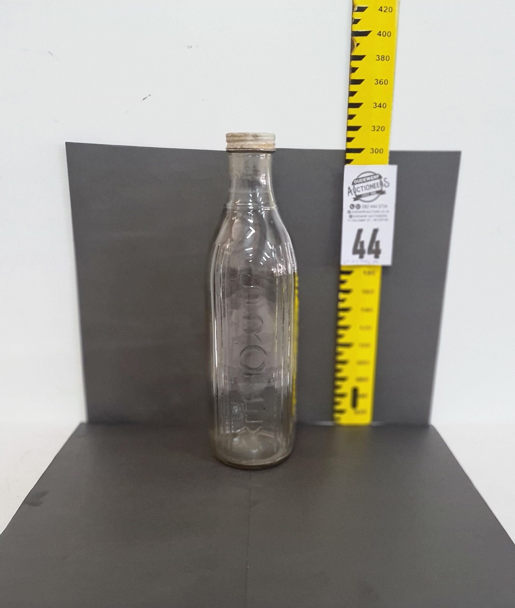 44.  Protex glass one quart oil bottle